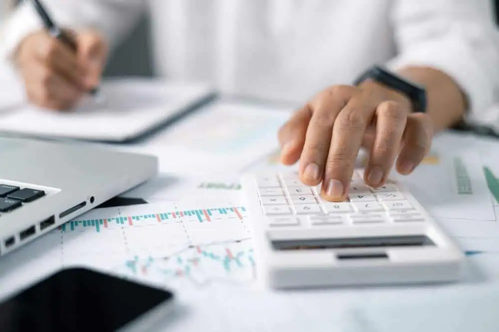 oman working on desk with using calculator, finance accounting.